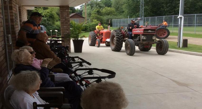 Tractor parade in front of Nine Mile Villa